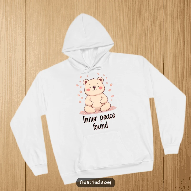 Funny bear hoodie, character meditating, petals falling, serene and cozy, giftable.